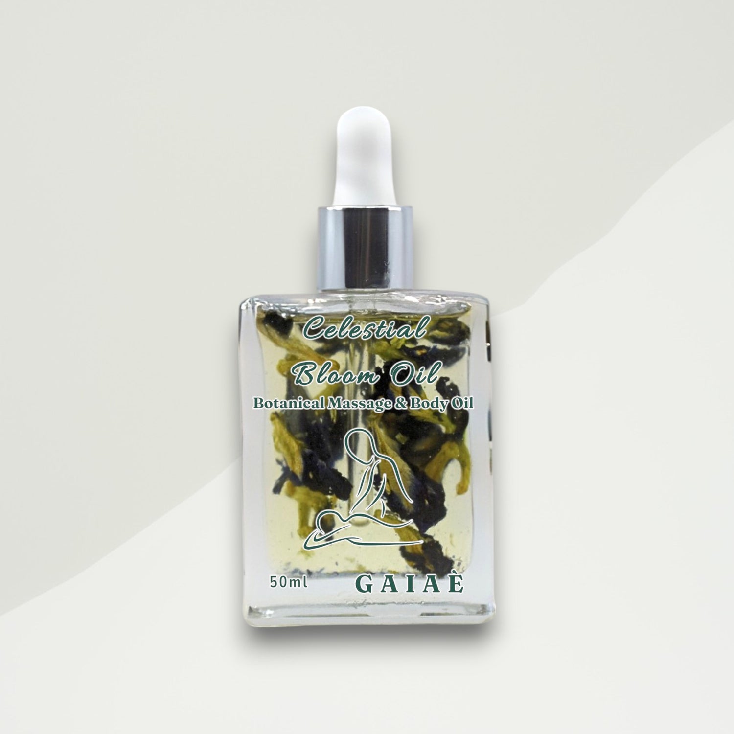 Bottle of Celestial Bloom Oil with butterfly pea flowers by Gaiaé. Botanical massage oil for glowing, soft skin.

